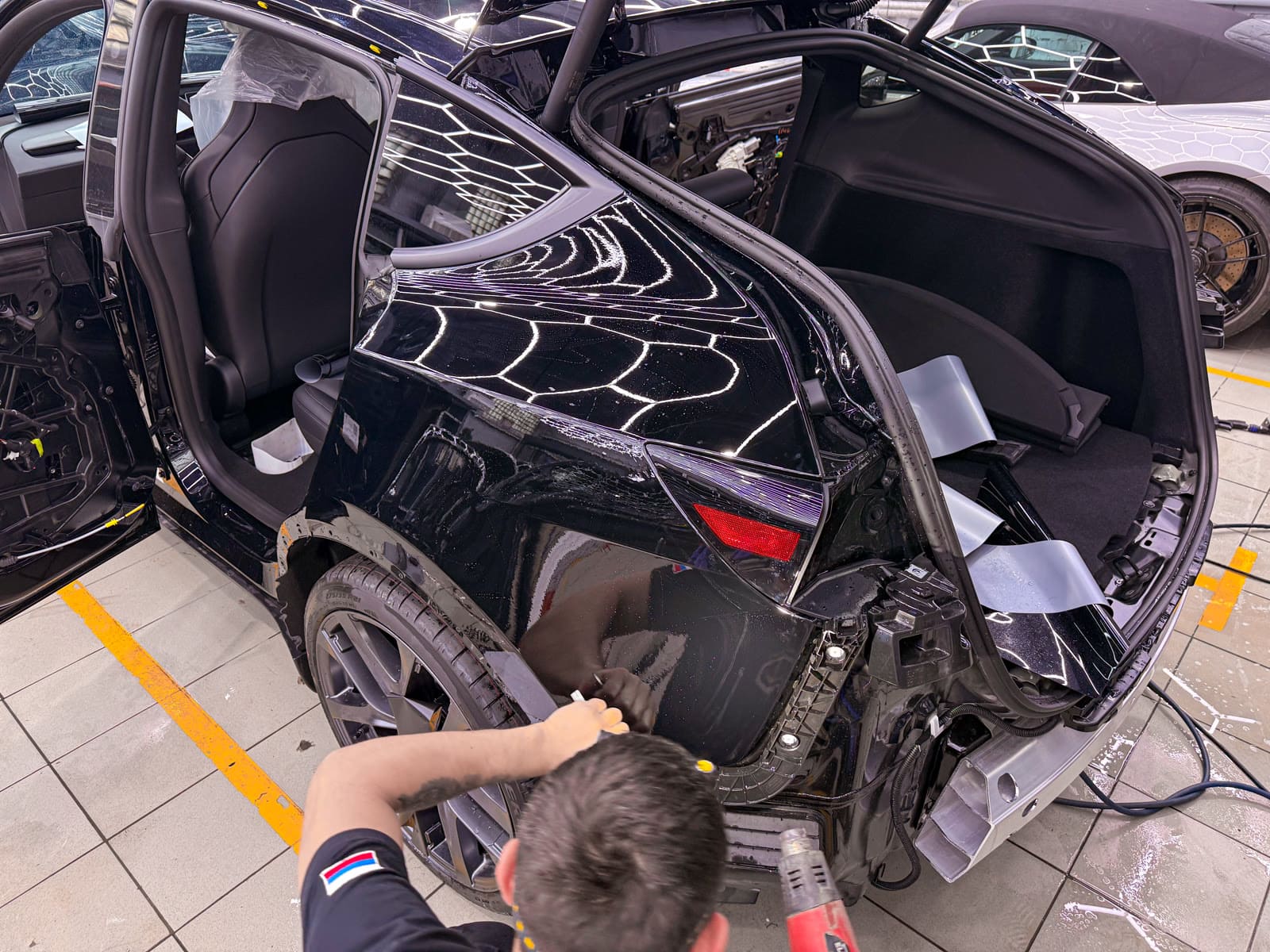 Защита Tesla Model Y чёрным полиуретаном — в процессе защиты глянцевых элементов, кадр 4